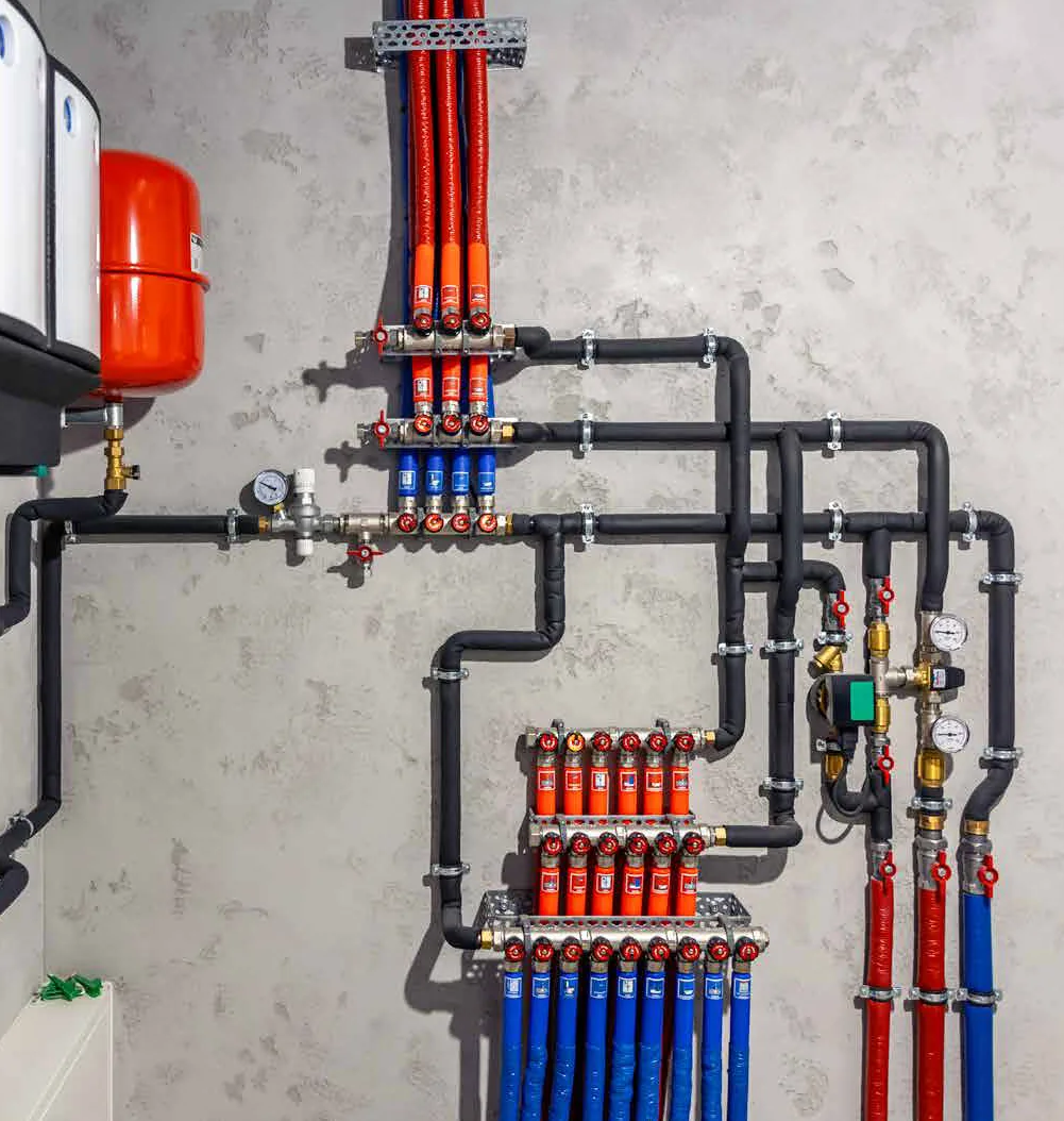 Heating manifold with red and blue pipework