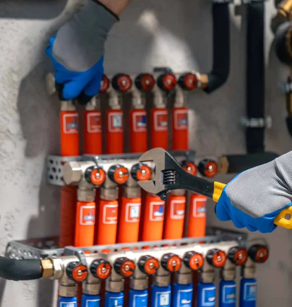 Technician tightening a manifold valve